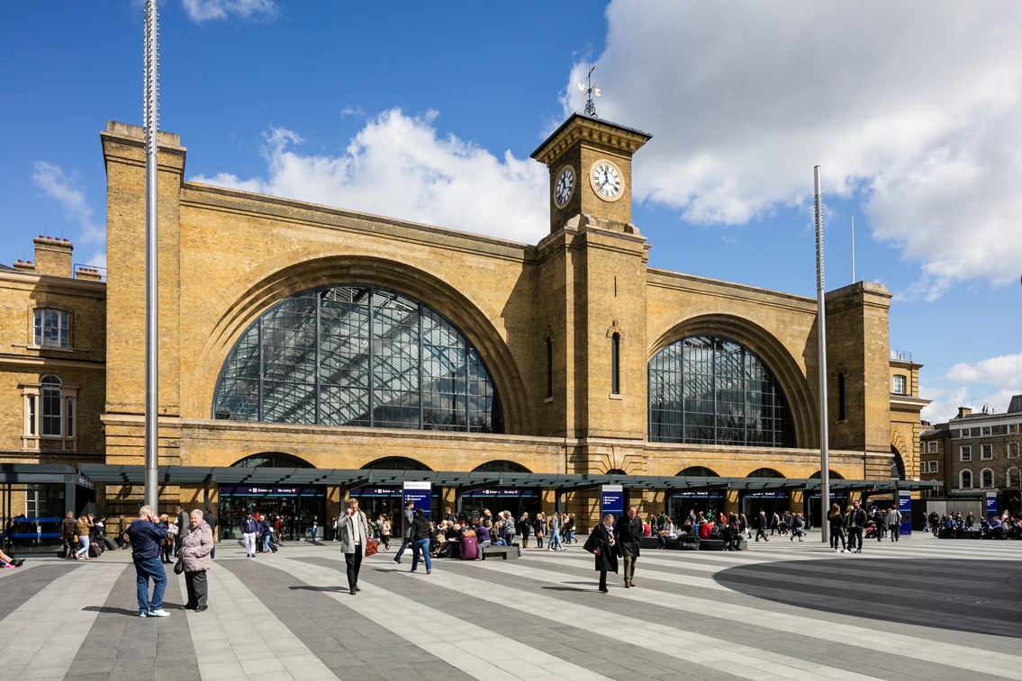 King's Cross railway station - King's Square from left: King's cross railway station
clock tower
king's square
train station
busy
people
crowds
day