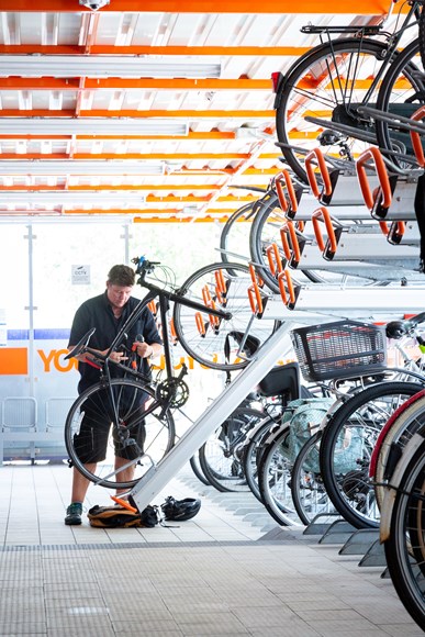 TfL Image  - A woman parking her bike