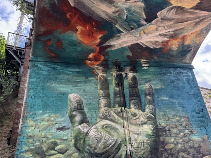 Mural Penny Pocket Park-2: The water scene which forms part of the mural works as a symbol for the River Aire running through the city not far from the park itself.