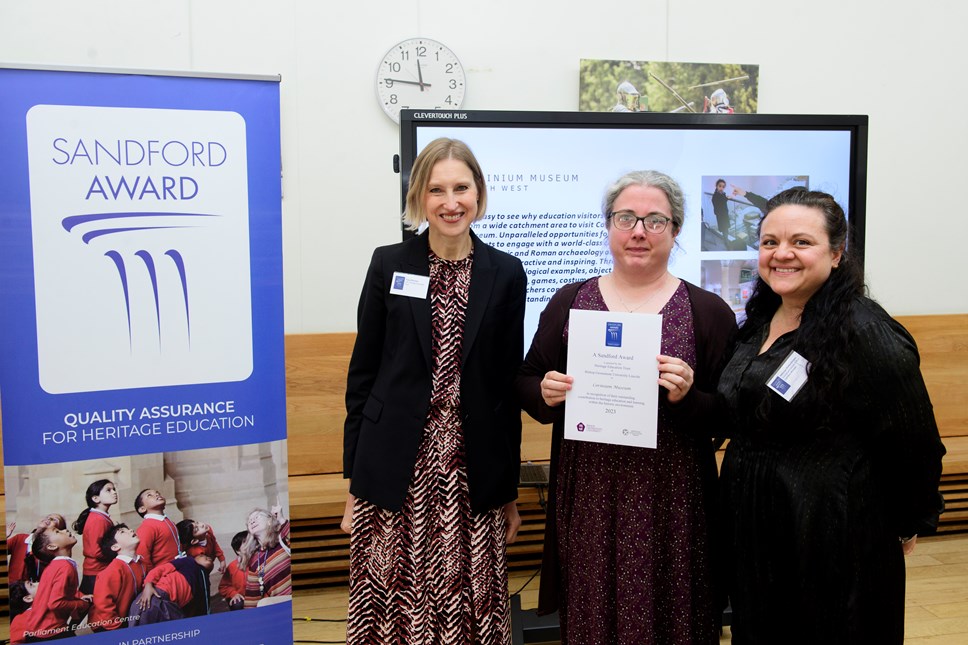 Photo: Left to Right: Tracy Borman presents the Sandford Award to Caroline Morris and Rebecca Shellenberger from Corinium Museum. Photo credit: Chris Vaughan Photography.