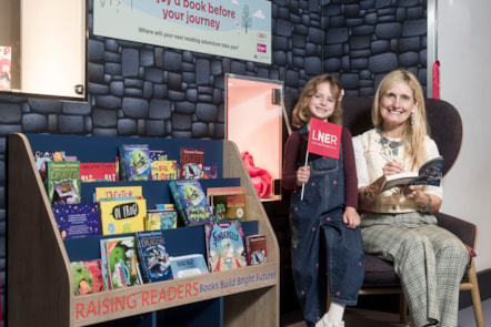 Cressida Cowell with the 'Raising Readers Book Nook' at Edinburgh Waverley Station
