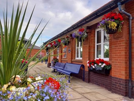 Image shows floral displays at St Annes on the Sea station (2022)