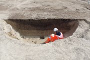 Archaeologist recording large Mesolithic pit in Linmere © MOLA: Archaeologist recording large Mesolithic pit in Linmere © MOLA