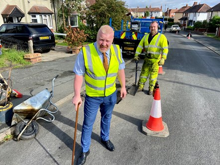 Cllr Damian Corfield, cabinet member for highways and environmental services, with Craig Reid, highways operative, repairing a pothole in Lady Greys walk, Stourbridge