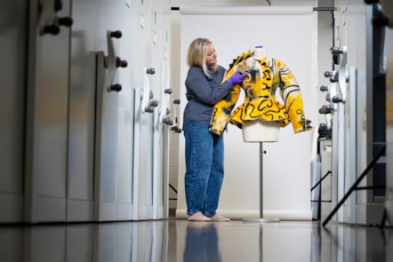 Curator Lisa Mason examines a yellow jacked designed by Jean Muir. Photo © Duncan McGlynn (4)