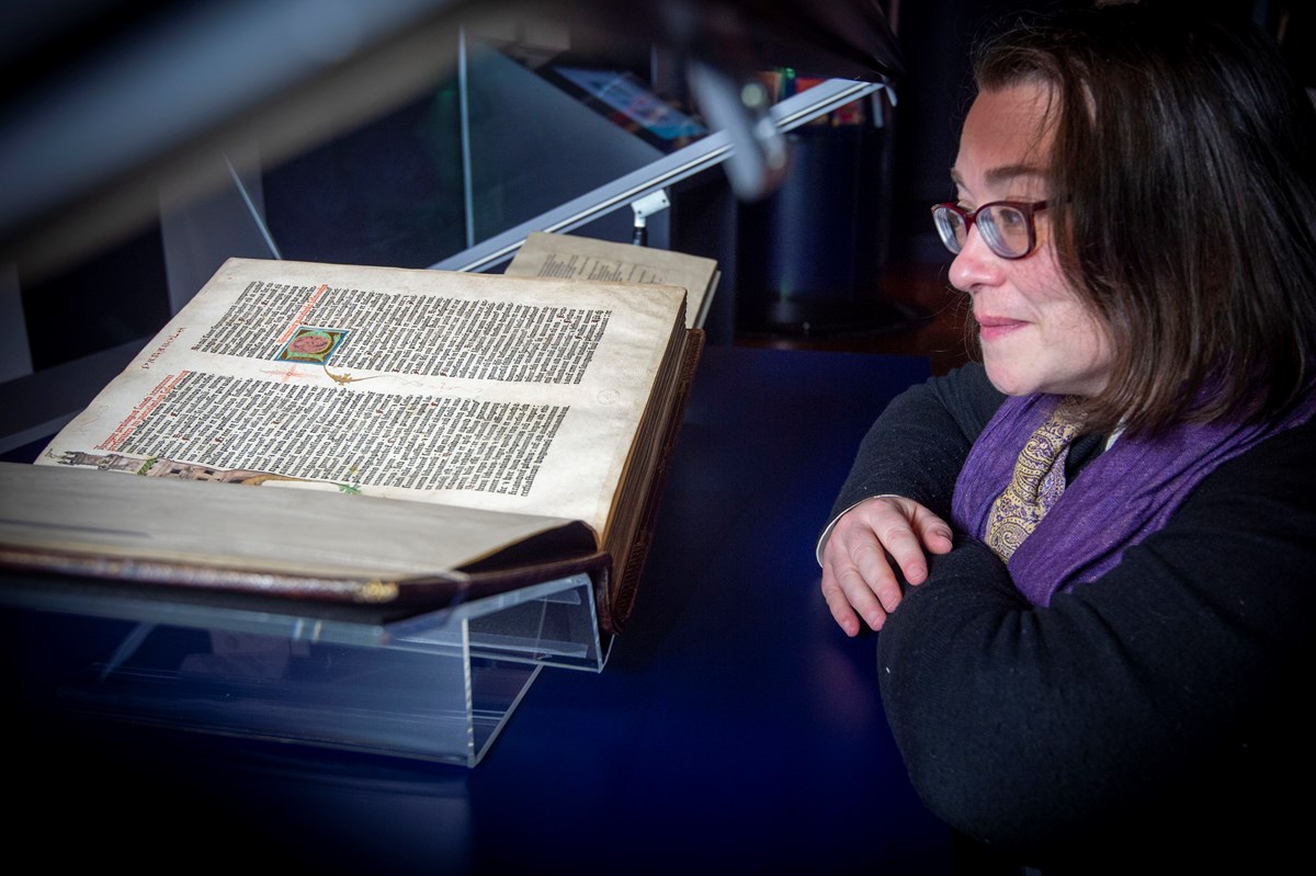 Head of Rare Books Helen Vincent with the Library's copy of the Gutenberg Bible. Credit: Neil Hanna