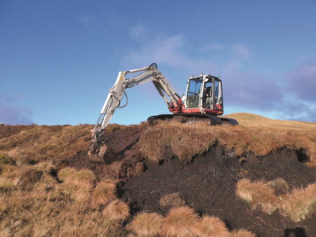 Peatland ACTION - Machine operator reprofiling a bare peat hag on a Peatland ACTION restoration site - Credit RJCooper - LLTNPA-PeatlandACTION