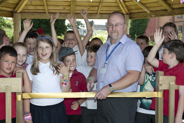 Selby winning poster 4: Head Teacher of Barlby Bridge Primary School David Barber and competition winner Wiki Czech do the honours of cutting the ribbon, officially opening their new outdoor classroom, donated by the Network Rail project team.