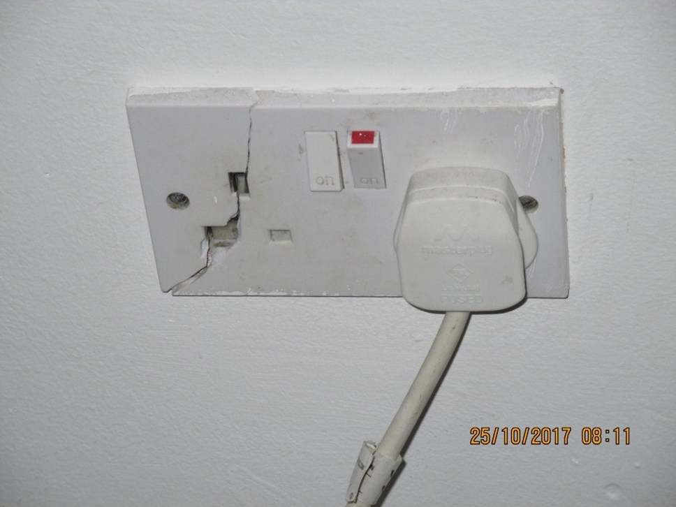 Cracked plug socket in living room, 28 Penderyn Way