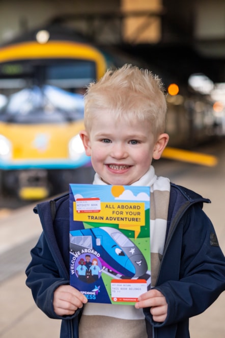 Ethan gets ready to board the train with his new TPE activity book