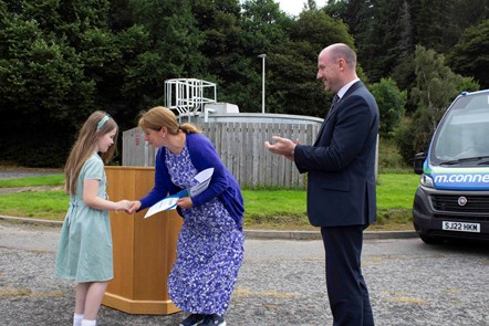 Charley Riley from Dyke Primary School receiving certificate from Council Leader Cllr Kathleen Robertson and Cabinet Secretary Neil Gray MSP