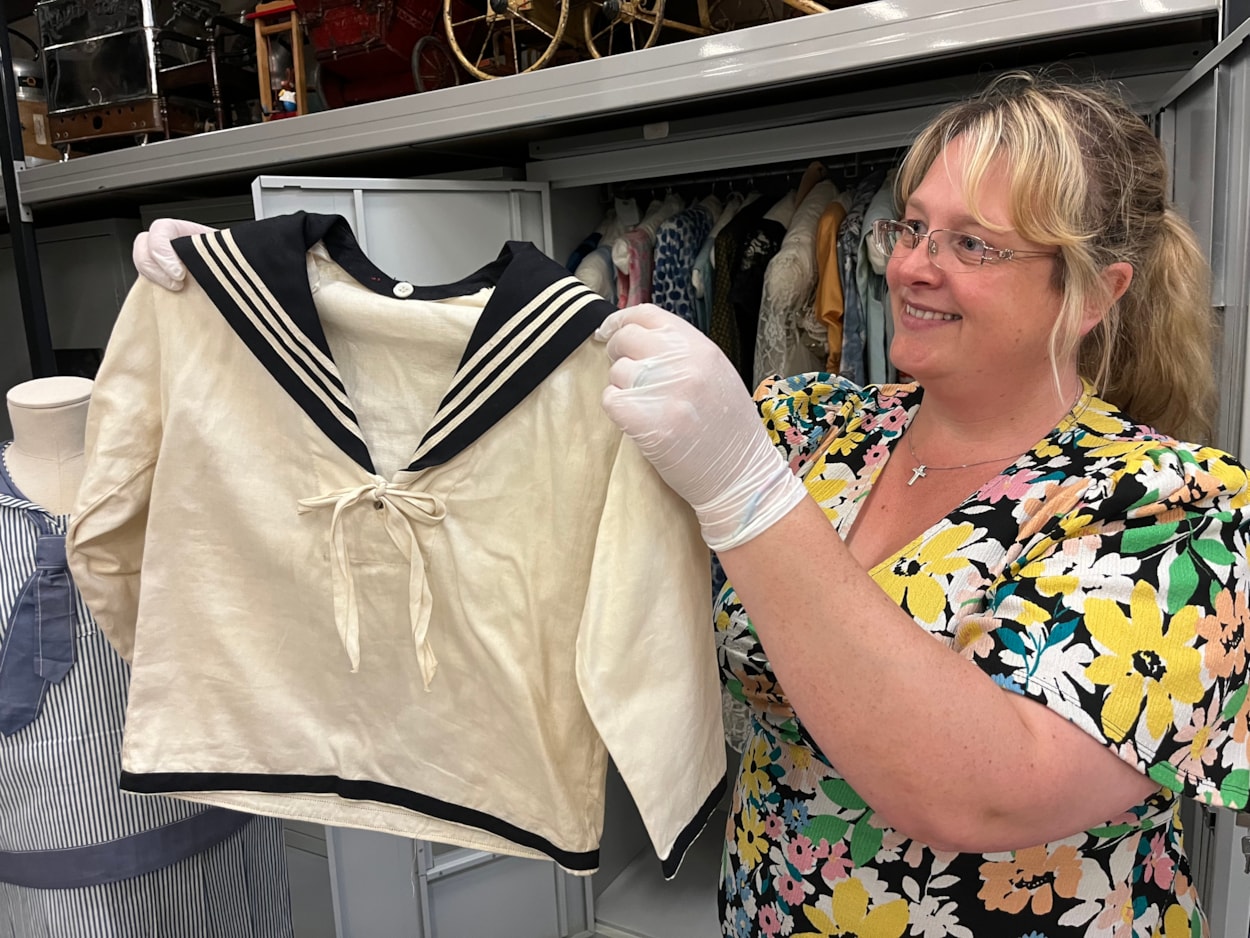 Sailor suits: Gemma Brown, site development officer at the Leeds Discovery Centre, with one of the eye-catching sailor suit style outfits in the Leeds collection.
The eye-catching naval attire includes a classic range of blue and white outfits, dresses and bellbottom trousers, looks which became hugely popular for children during the late 19th and early 20th centuries.
The suits are among an array of historic fashions which will be explored in an upcoming workshop at Leeds Discovery Centre looking back on centuries of fabulous clothes and costumes.