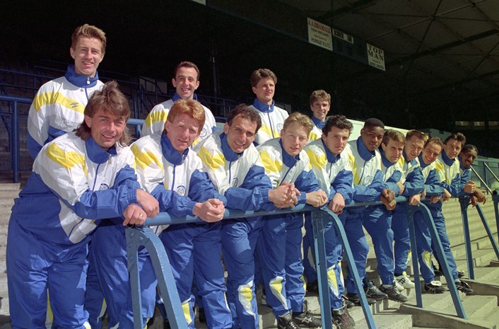 Leeds United 1990. Image: © Varley Picture Agency.: Leeds United team in 1990 wearing tracksuits in the blue and yellow colourway. The early 90s were a successful time for the team, and in 1992 Leeds won their third League trophy. Image: © Varley Picture Agency