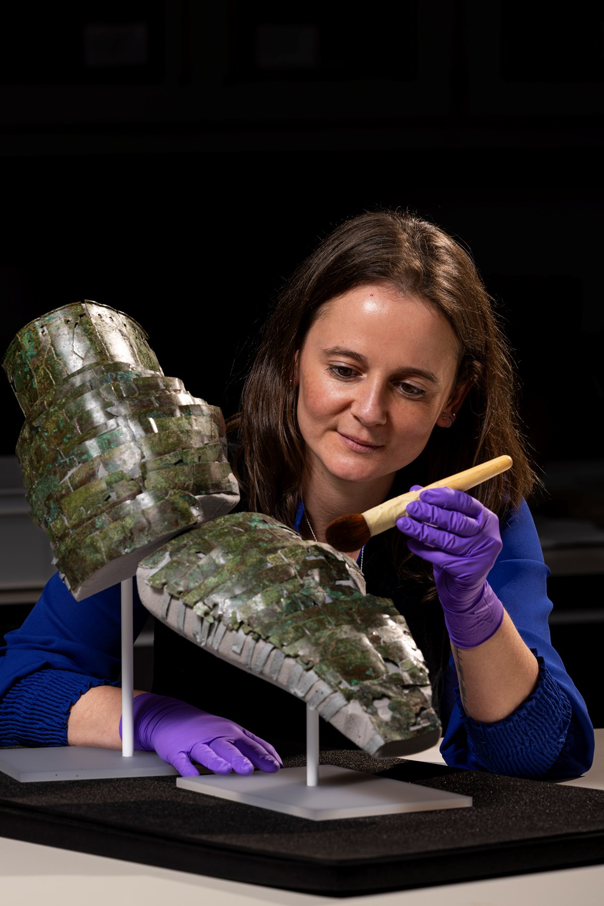 Conservator Bethan Bryan with the Roman arm guard. Photo (c) Duncan McGlynn (5)