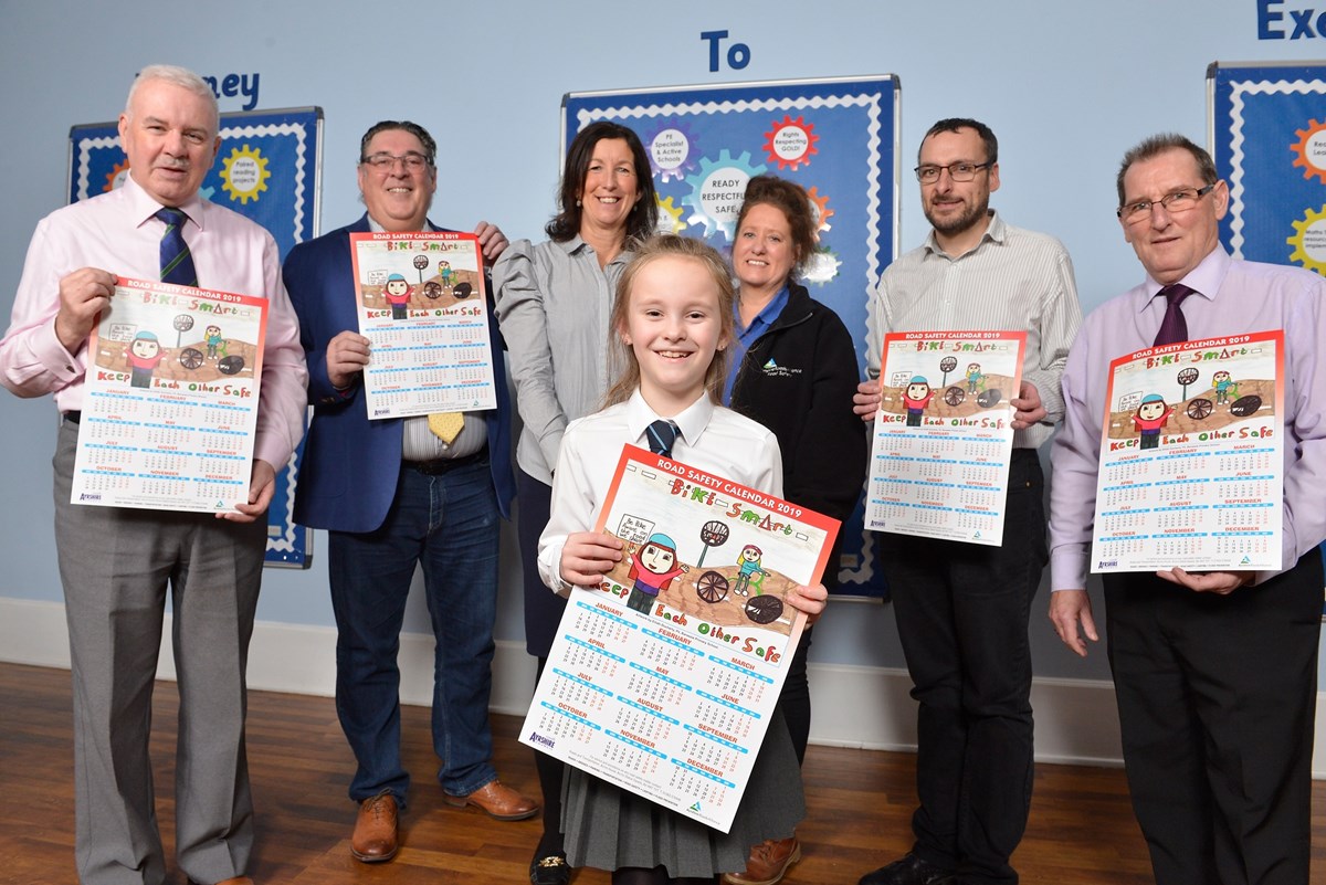Eilidh Docherty with her winning entry in the Ayrshire Roads Alliance's South Ayrshire Road Safety Calendar 2019 competition on Thursday 29 November 2018 in Troon, South Ayrshire. With Eilidh are Councillor Peter Convery, Councillor Ian Cochrane, Angela Swan (Junior Road Safety co-ordinator), Mary Garrett (Assistant Road Safety Officer), Councillor Craig Mackay and Councillor Philip Saxton.: Eilidh Docherty with her winning entry in the Ayrshire Roads Alliance's South Ayrshire Road Safety Calendar 2019 competition on Thursday 29 November 2018 in Troon, South Ayrshire. With Eilidh are Councillor Peter Convery, Councillor Ian Cochrane, Angela Swan (Junior Road Safety co-ordinator), Mary Garrett (Assistant Road Safety Officer), Councillor Craig Mackay and Councillor Philip Saxton.