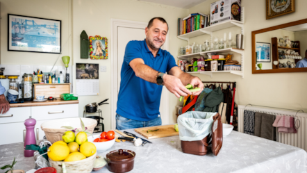 A resident recycles their food waste while cooking-2