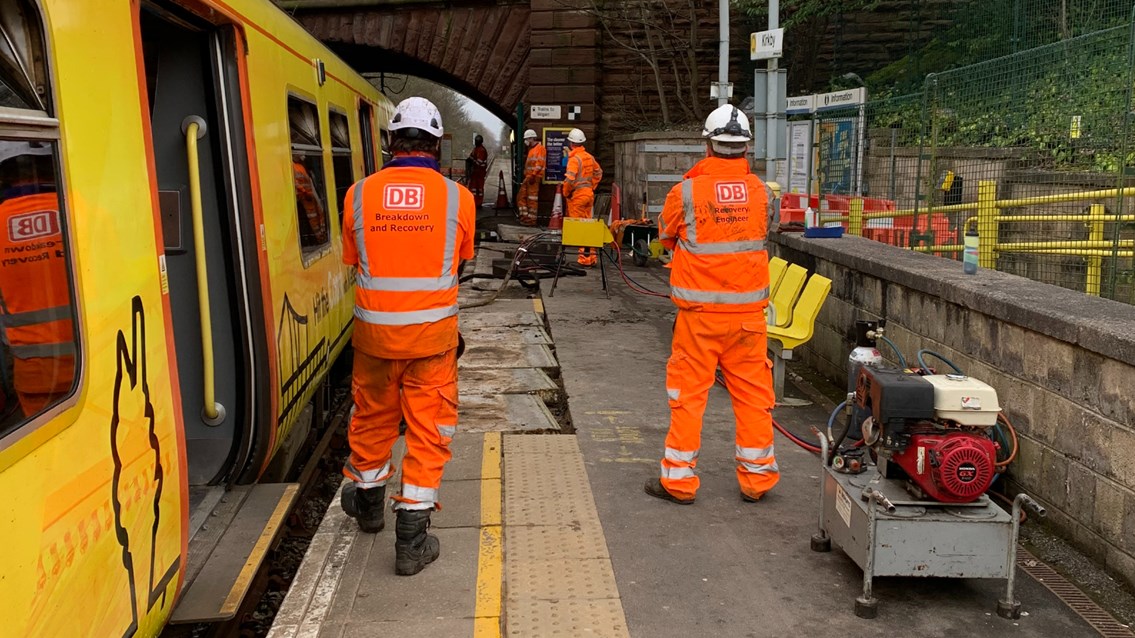 Recovery team getting derailed Merseyrail train back onto the track at Kirkby station