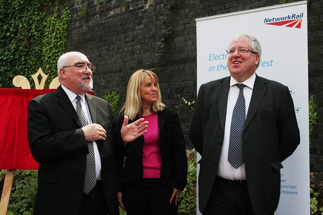 Secretary of State Patrick McLoughlin unveils a plaque at Eccles Station: Secretary of State Patrick McLoughlin unveils a plaque at Eccles Station, commemorating the electrification work on the world's oldest public railway, pictured with London North Western Director of Route Asset Management Jane Simpson and mayor of Salford Ian Stewart