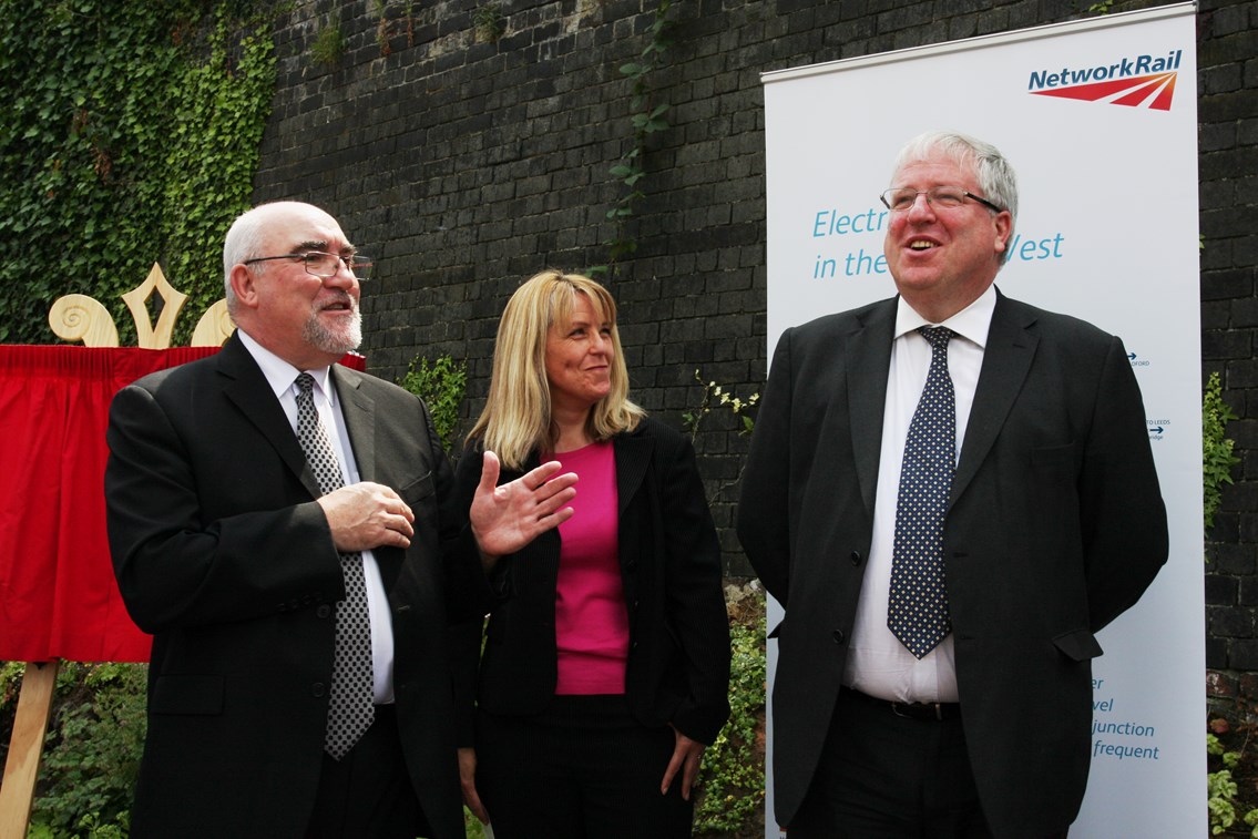 Secretary of State Patrick McLoughlin unveils a plaque at Eccles Station: Secretary of State Patrick McLoughlin unveils a plaque at Eccles Station, commemorating the electrification work on the world's oldest public railway, pictured with London North Western Director of Route Asset Management Jane Simpson and mayor of Salford Ian Stewart
