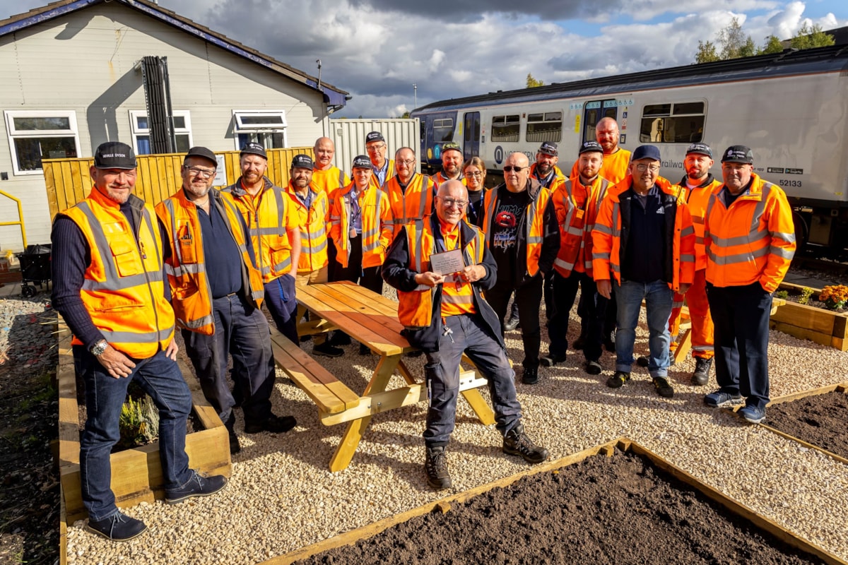 Image shows Mike with his colleagues at Newton Heath