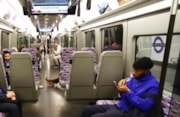 TfL Image - Customer using mobile phone on Elizabeth line train: TfL Image - Customer using mobile phone on Elizabeth line train