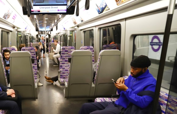 TfL Image - Customer using mobile phone on Elizabeth line train