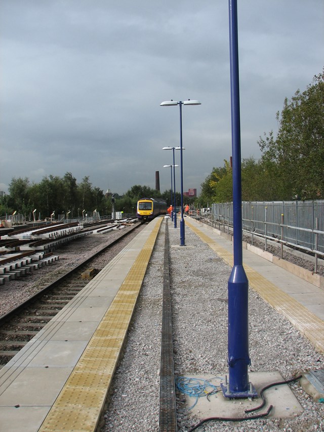 Stalybridge track renewal work: A First TransPennine Express train passes the newly extended Huddersfield/Leeds-bound platform at Stalybridge. The new bay platform is to the right.