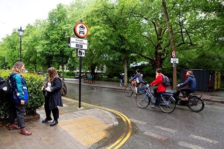 People stand, talk, and cycle on Highbury Place part of the Highbury LTN