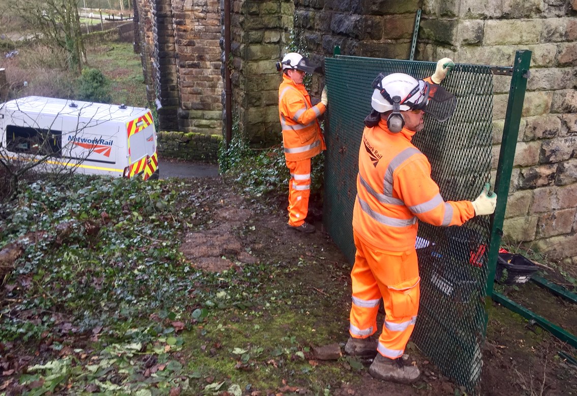 Urgent work to stop trespassers in Uppermill from risking their lives: Network Rail workers installing further railway safety fencing at Den Lane in Uppermill 17 December 2018