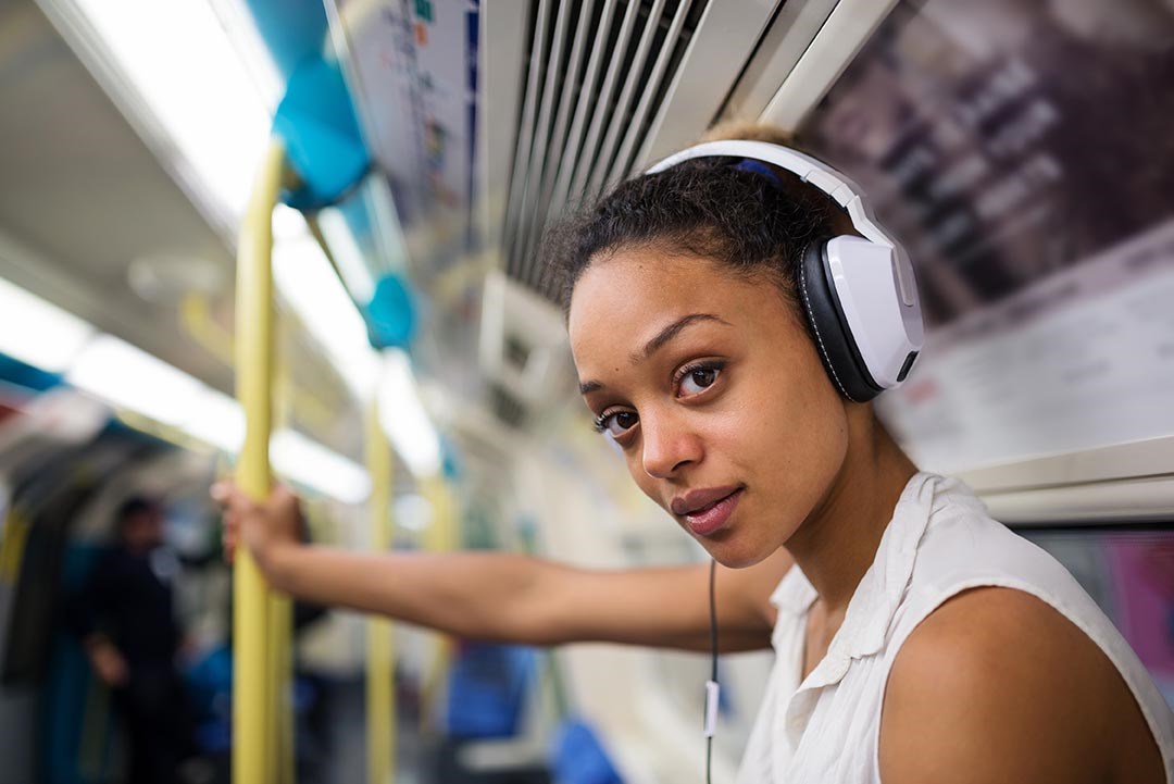 Young woman on Tube looking directly at camera