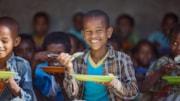 RS22812 Children enjoying their meal: RS22812 Children enjoying their meal