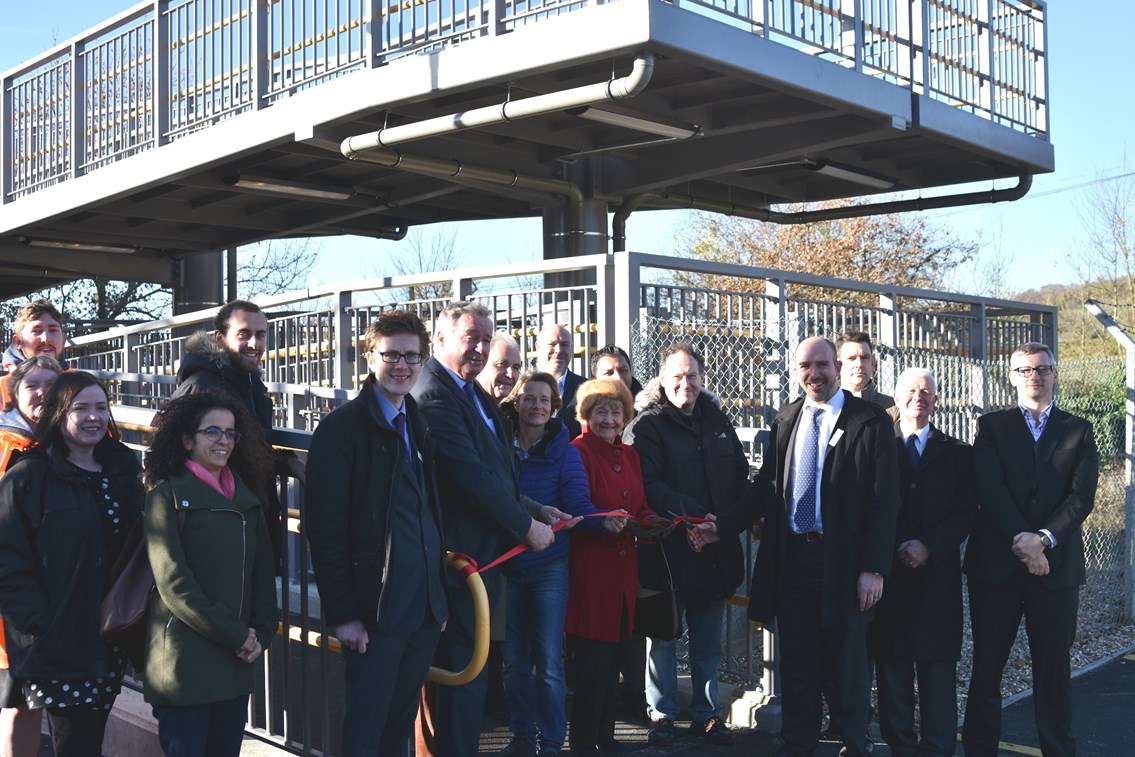 Stuart Kistruck, director of route asset management at Network Rail cuts the ribbon to officially open Rosa's bridge in Gomshall.: Also attending the opening were: David Gould, Rosa Sigal's great-nephew; Beatrice Gould, Rosa Sigal's niece; Tom Pierpoint, Great Western Railway; Sir Paul Beresford, MP for Mole Valley; Cllr Keith Taylor, Surrey County Council; Cllr David Wright, Guildford Borough Council; Cllr Candace Brooke, Shere Parish Council; representatives from Network Rail and Osborne's, the appointed contractor.