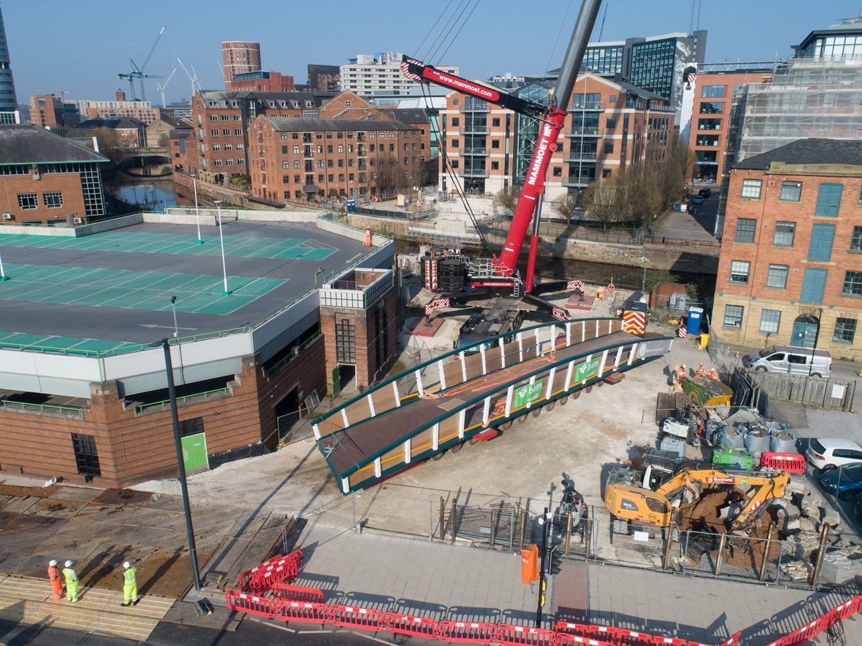 David Oluwale bridge installation: The David Oluwale bridge is lifted into place over the River Aire in Leeds. Engineers working on the David Oluwale bridge completed one of the project’s major milestones over the weekend, with cranes carefully placing the 40 tonne structure over the river where it will connect Sovereign Street to Water Lane. Credit BAM Nuttall.