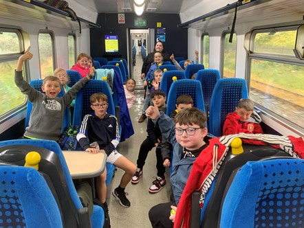 This image shows children from Shackles off enjoying their trip on a Northern train