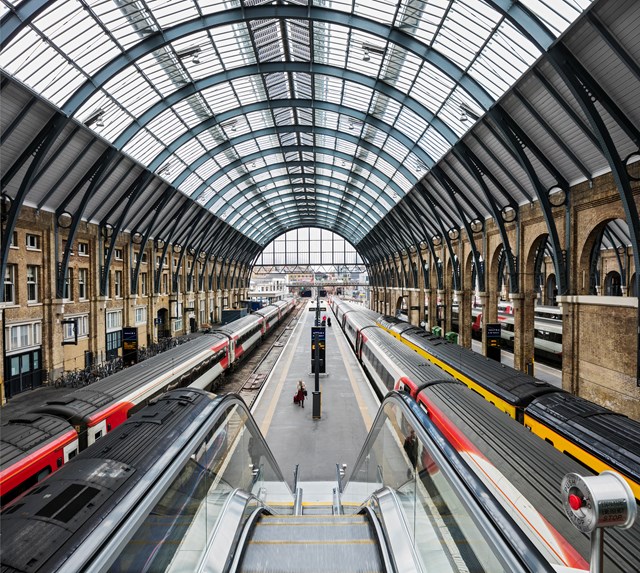 King's Cross railway station - trains at busy platform - view from escalator