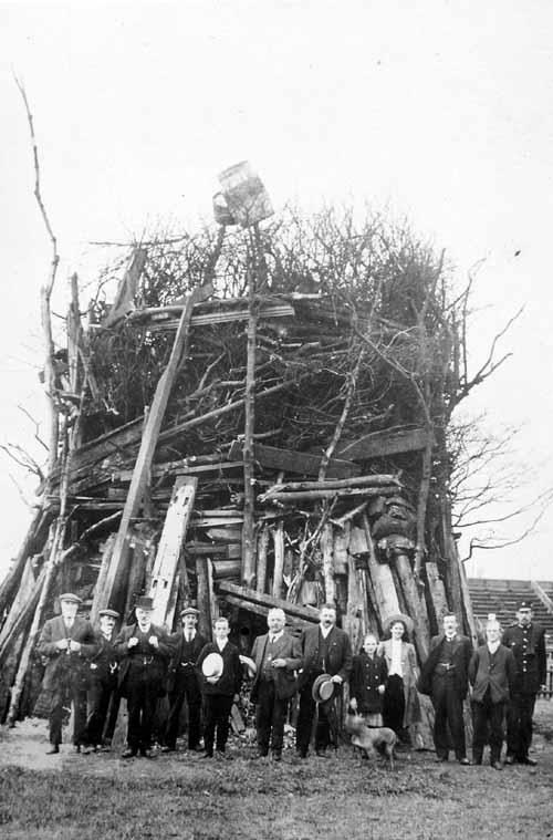 Leeds coronations: Morley Corporation's bonfire for the coronation of King George V on Morley Rugby Ground. Among the people gathered in front are the Town Clerk, Fred Thackray, and his daughter, and also police inspector Tom Hutchinson. Photograph from the David Atkinson Archive.