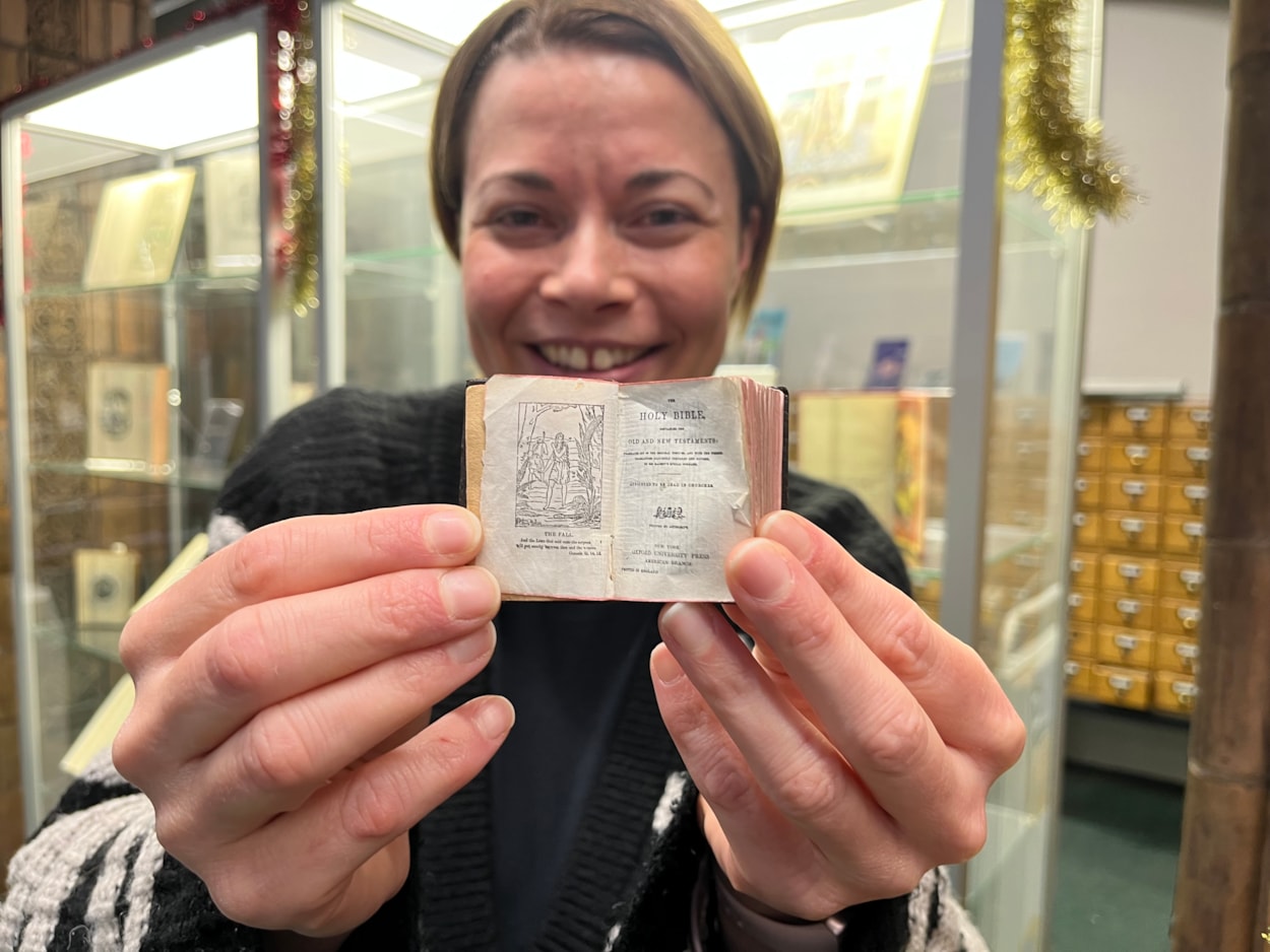 Library Christmas books: Library and digital assistant Anna Jones with a miniature copy of the King James Bible, which is among the books on display, giving visitors a rare chance to see a highly unusual example of the original Christmas story.
Little enough to fit in the palm of a hand, and with text so tiny it can only be read with a magnifying glass, the Bible dates from around 1911, and is thought to be one of the smallest examples of its kind anywhere in the world.