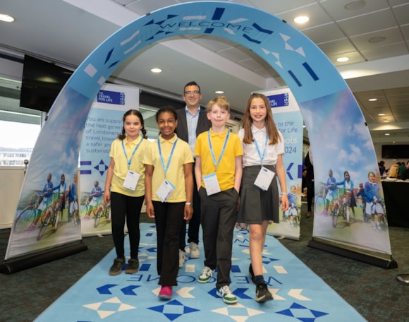 London schoolchildren make strides towards a sustainable future at TfL award ceremony: TfL Image - London’s Walking and Cycling Commissioner, Will Norman joins students from Gillespie Primary School at the Travel for Life Top school awards