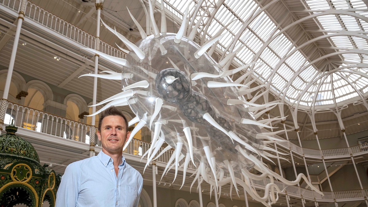 Artist Luke Jerram and his sculpture E.coli at the National Museum of Scotland. Photo © Neil Hanna. low res