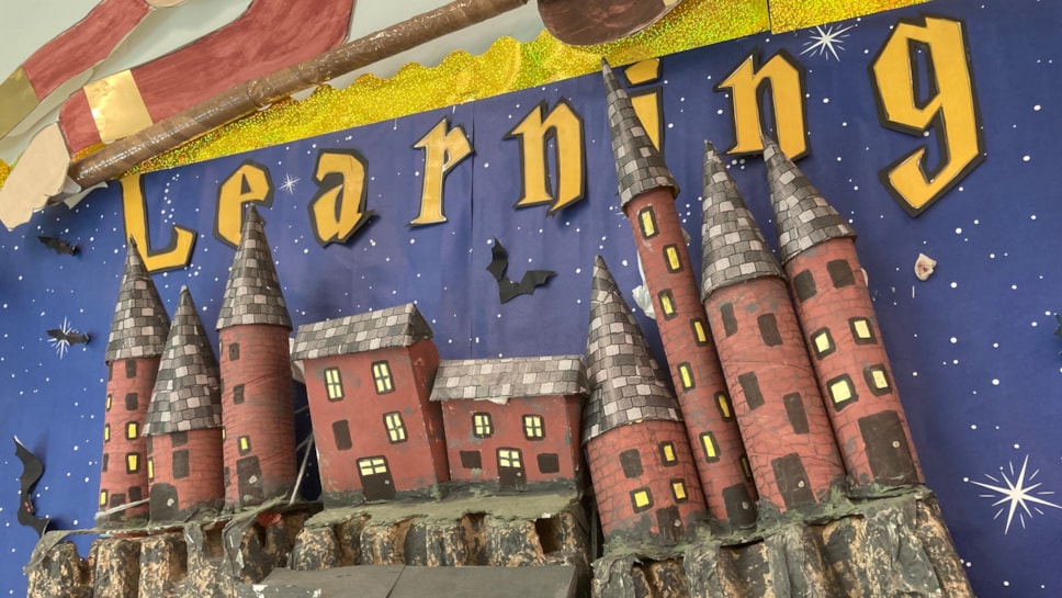 A colourful school poster showing a castle and the word Learning above