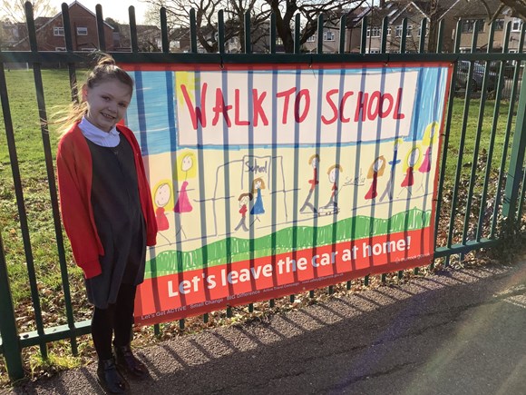 Schools team up with Thurrock Council and bring pupils’ winning active travel designs to life: A student at Horndon on the Hill Church of England Primary School with her winning banner