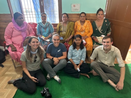 University of Cumbria past and present students Megan Richards, Hannah Wright, and Reuben Hibbert with members of the local community at a village workshop in the Kullu District during their recent Turing Scheme funded visit to India