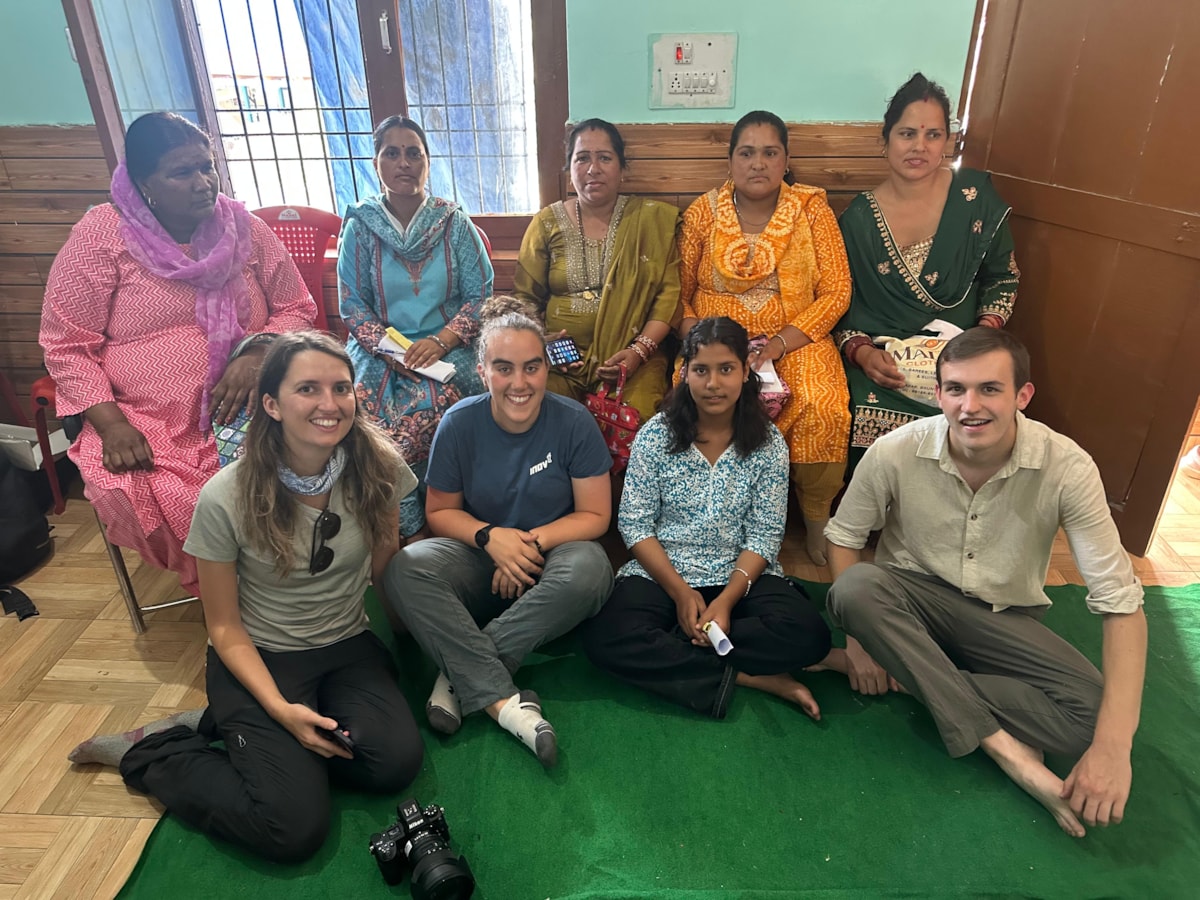 University of Cumbria past and present students Megan Richards, Hannah Wright, and Reuben Hibbert with members of the local community at a village workshop in the Kullu District during their recent Turing Scheme funded visit to India