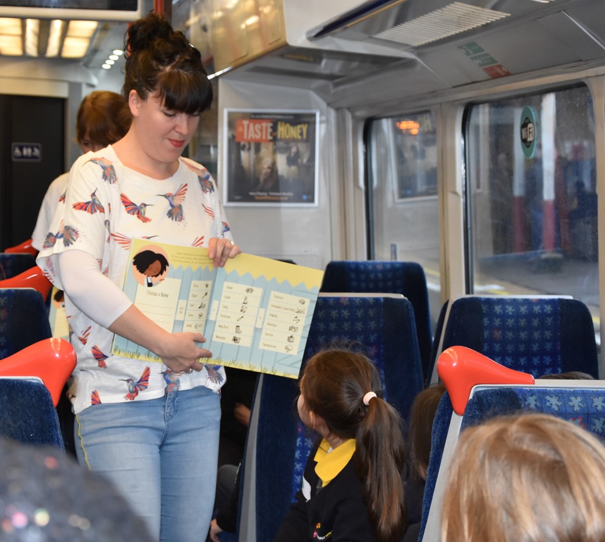 Author Sarah Coyle reads to pupils from Edward Wilson Primary School on-board Chiltern Railways' Story Train