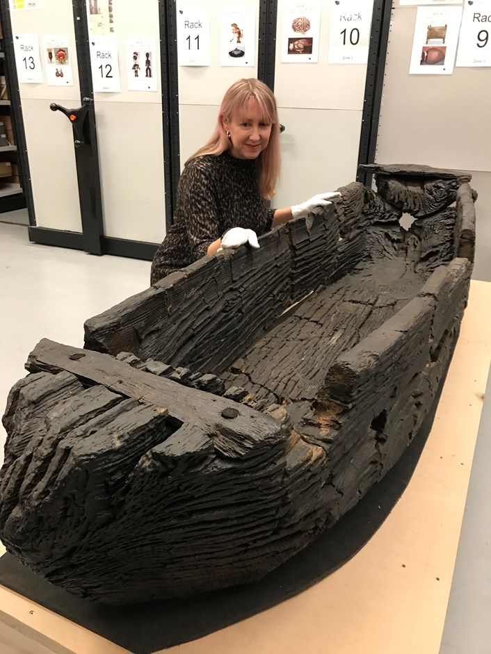 Giggleswick Tarn logboat: Kat Baxter, Leeds Museums and Galleries curator of archaeology with the centuries-old carved logboat, which dates from the 1300s. The  watercraft had lain beneath the soil for more than 500 years before being discovered by Joseph Taylor in 1863 while he was digging some drainage works near Giggleswick Tarn in North Yorkshire.