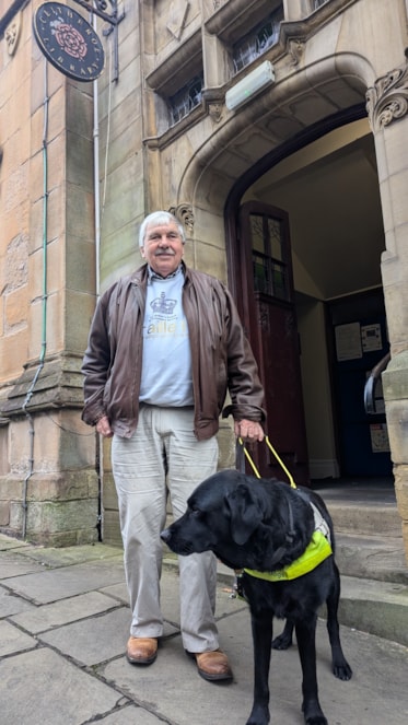 Chris and his guide dog outside Clitheroe Library