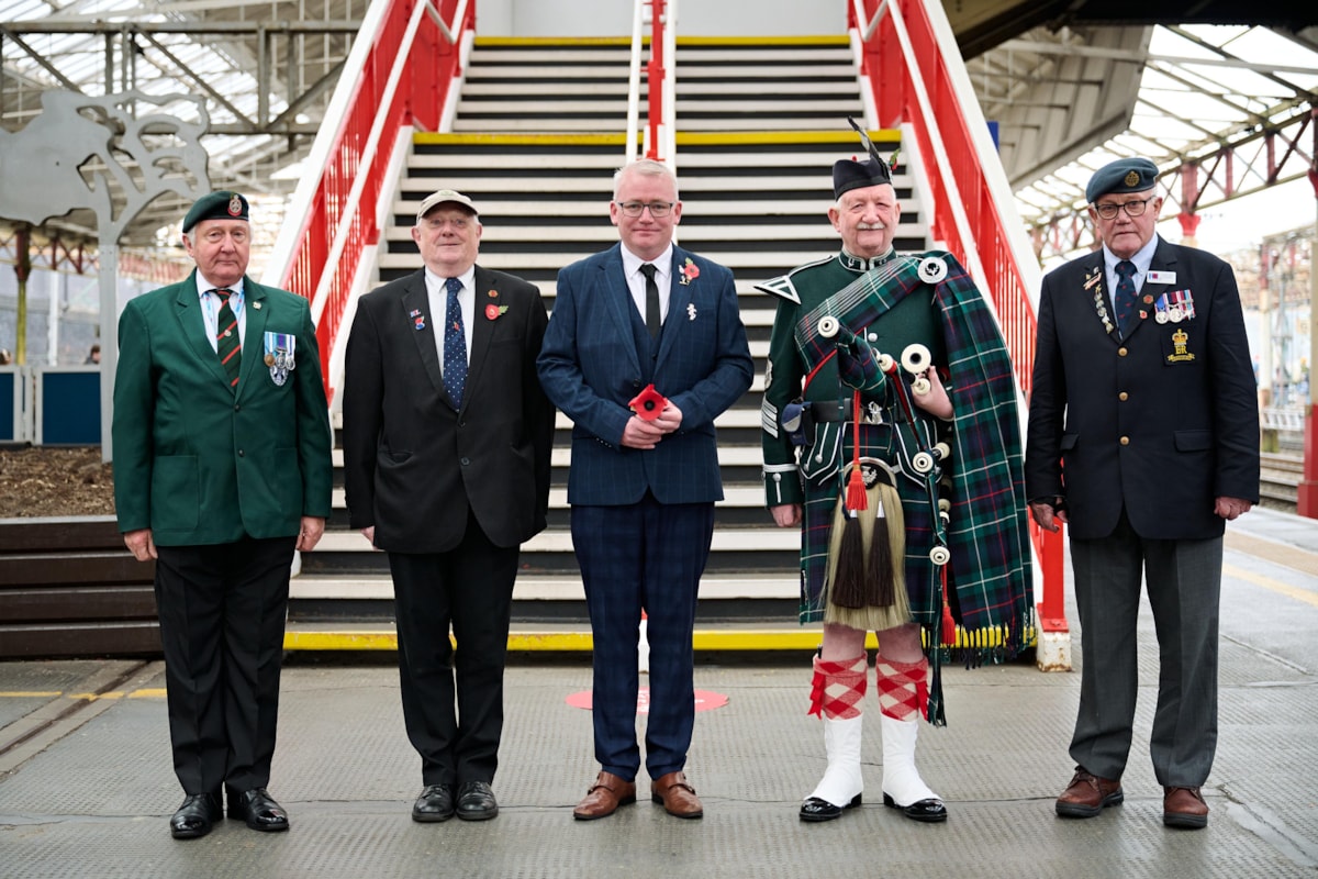 Avanti West Coast Customer Service Assistant, Anthony Stanley (centre), who served in the Army, joined Royal British Legion representatives at Crewe station to present a posy of poppies to the wreath