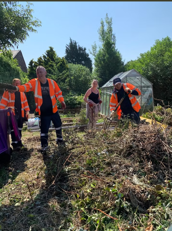 Network Rail volunteers and local residents clearing vegetation at community work day: Network Rail volunteers and local residents clearing vegetation at community work day