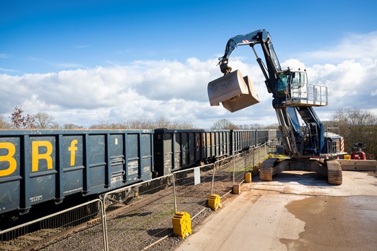 Excavator preparing to unload a train at teh Quainton railhead Feb 2024