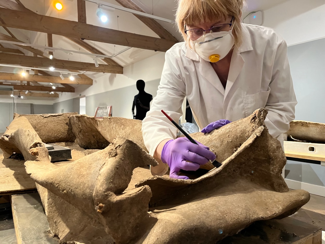 Living with Death coffin display: Emma Bowron, conservator with Leeds Museums and Galleries, works on the ancient lead coffin which lay buried in a Leeds field for more than 1,600 years.
The astonishing discovery, described by experts as a once-in-a-lifetime find, was made during excavation work by West Yorkshire Archaeological Services in a previously unknown site near Garforth.
It will go on display at Leeds City Museum in May as part of a new exhibition called Living with Death.